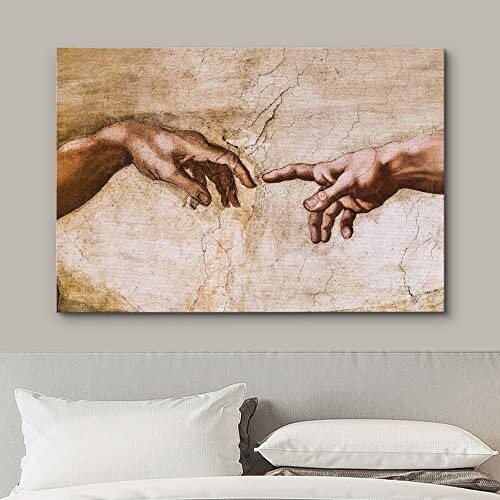 Close-up of hands from Michelangelo's Creation of Adam on a wall.