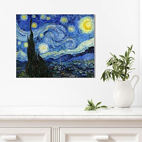 Wall art of Van Gogh's Starry Night above a white cabinet with a plant.